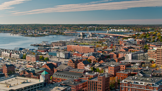 Aerial shot of Downtown Portland, Maine on a sunny morning in Fall, looking across the rooftops towards the Casco Bay Bridge. \n   \nAuthorization was obtained from the FAA for this operation in restricted airspace.