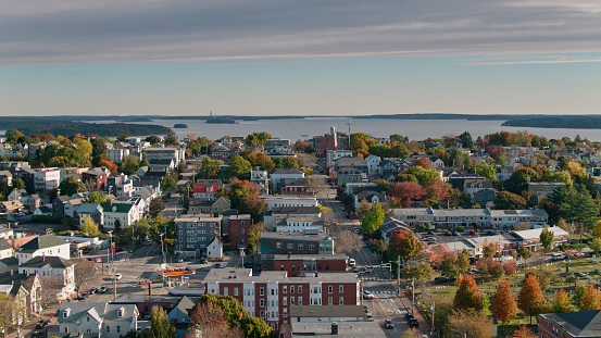 Aerial shot of residential streets in Portland, Maine, looking across rooftops in the East End towards the islands in Casco Bay.

Authorization was obtained from the FAA for this operation in restricted airspace.