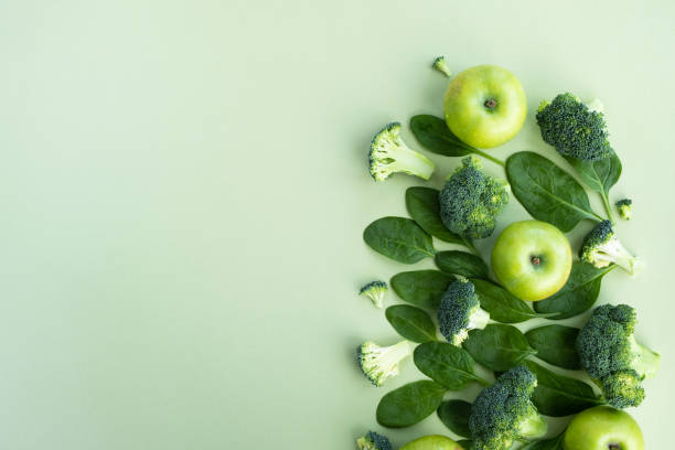 istock Green vegetables and fruits on light background. 1365883319