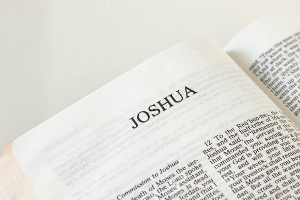 istock Joshua Bible open Book on white background 1365884353