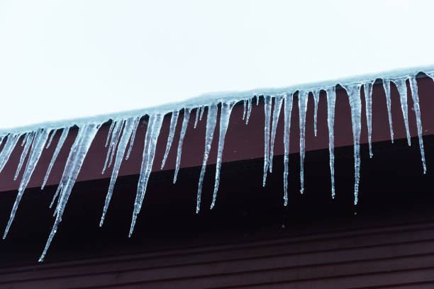 North American Winter Post Winter Storm Icicles are formed on the roof icicles melting stock pictures, royalty-free photos & images