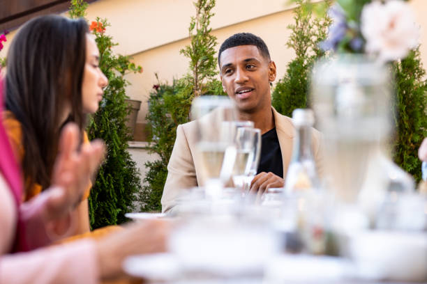 istock Family and friends celebrating at dinner on a rooftop terrace 1365885271