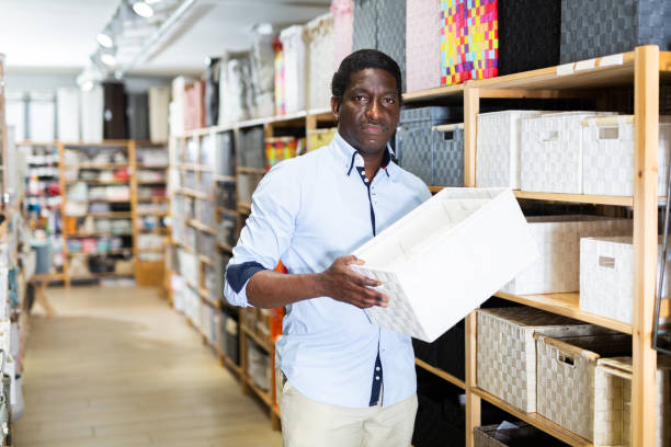 istock Focused African American looking for decorative boxes at store 1365887268
