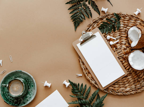 istock Desktop mockup planner. Flat lay with clipboard, coffee cup and green leaves on brown background.Zero waste, eco friendly, natural organic concept. 1365888208