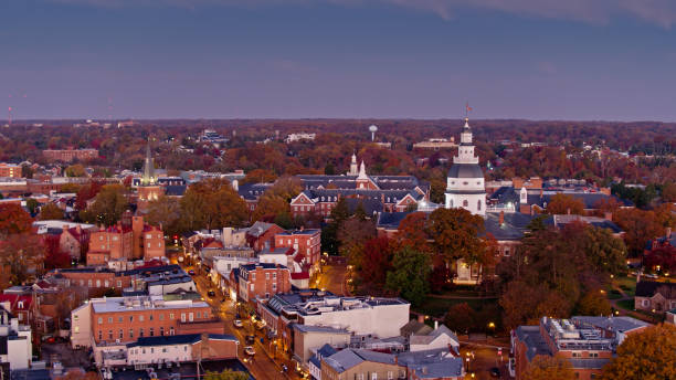 Drone Shot of the Maryland State Capitol and Downtown Annapolis Aerial shot of Annapolis at twilight before sunrise of a Fall morning, looking over autumnal trees, historic downtown buildings and the dome of the Maryland State House. maryland us state photos stock pictures, royalty-free photos & images