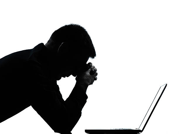 istock Businessman silhouette in front of laptop 136588840