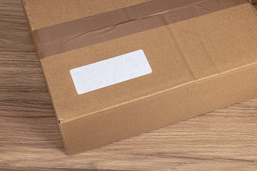 White label on a cardboard box delivery, copy space