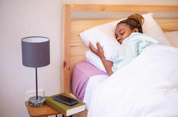 istock African woman sleeping comfortably on bed 1365893061