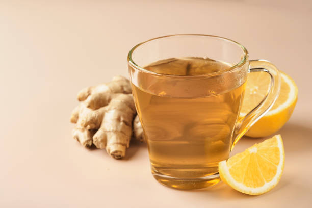 istock Ginger tea. Cup of ginger tea with lemon, honey and mint on beige background. Concept alternative medicine, natural homemade remedy for cold and flu. Top view. Free space for your text. 1365893791