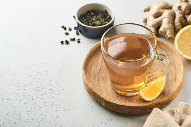 istock Ginger tea. Cup of ginger tea with lemon, honey and mint on grey background. Concept alternative medicine, natural homemade remedy for cold and flu. Top view. Free space for your text. 1365893910