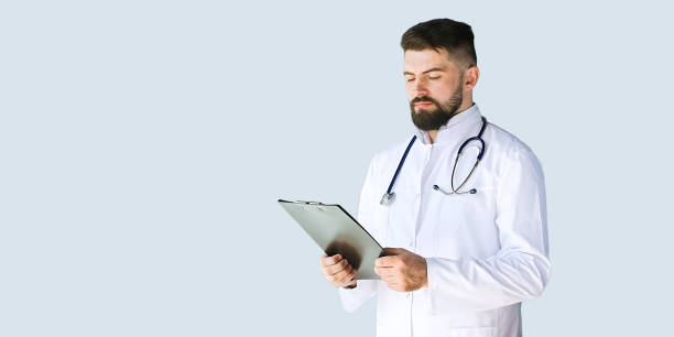 istock Doctor thinking about diagnosis on clipboard isolated on gray background 1365895102