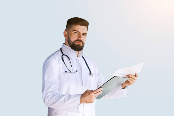 istock Doctor thinking about diagnosis on clipboard isolated on gray background 1365895107