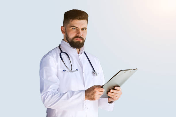 istock Doctor thinking about diagnosis on clipboard isolated on gray background 1365895114