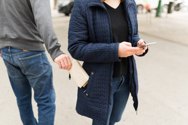 istock Man pickpocketing a woman's bag 1365895232