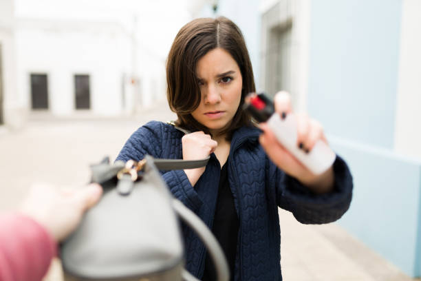 Fearless woman defending herself from an attacker stock photo