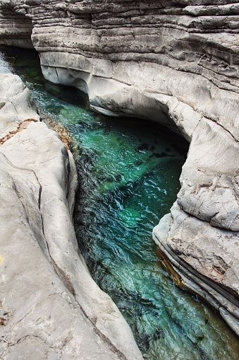 Turquoise mountain river between rocks