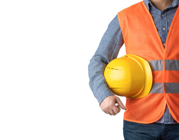 Technician man standing with yellow safety helmet isolated on white background.  Front view