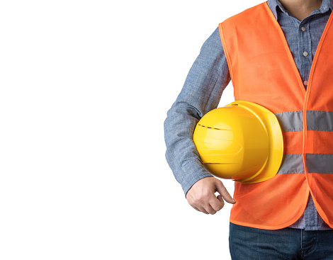 Technician man standing with yellow safety helmet isolated on white background.  Front view