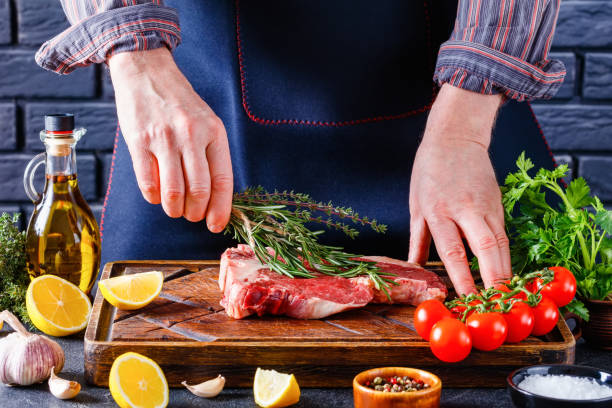 istock man cooking beefsteak on a kitchen, close-up 1365896674
