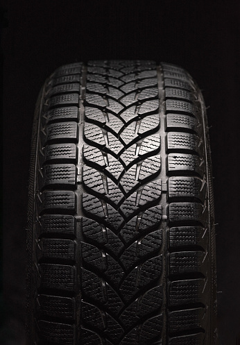 Winter tires isolated on black background