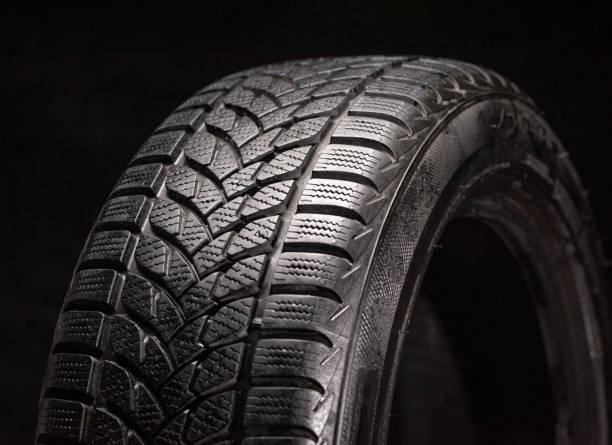 istock Winter tires isolated on black background 1365897854