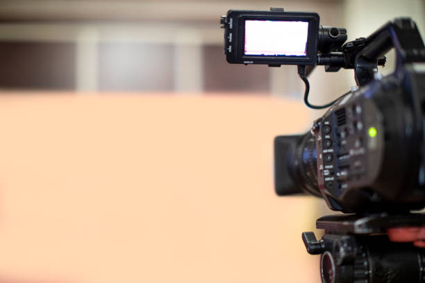 istock Video camera taking live video streaming with people working background at meeting room. Selective focus. stock photo. 1365898404