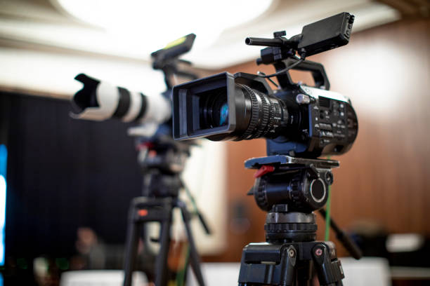 istock Video camera taking live video streaming with people working background at meeting room. Selective focus. stock photo. 1365899715