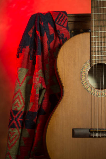 istock Classic guitar on red vintage background 1365899749
