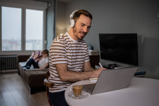 istock Man talking on a video call while his son is at home 1365900588