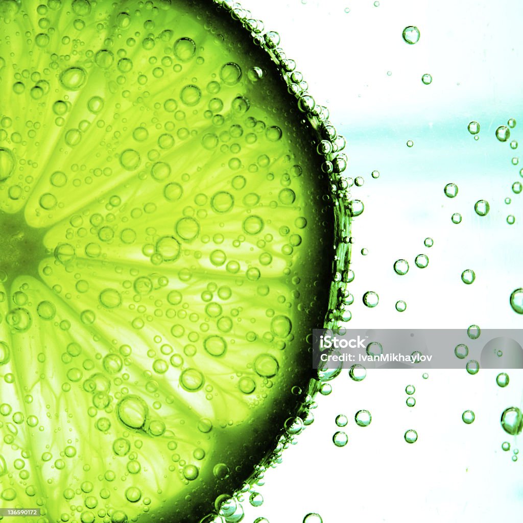 lime slice in water lime slice in water bubbles Blue Stock Photo