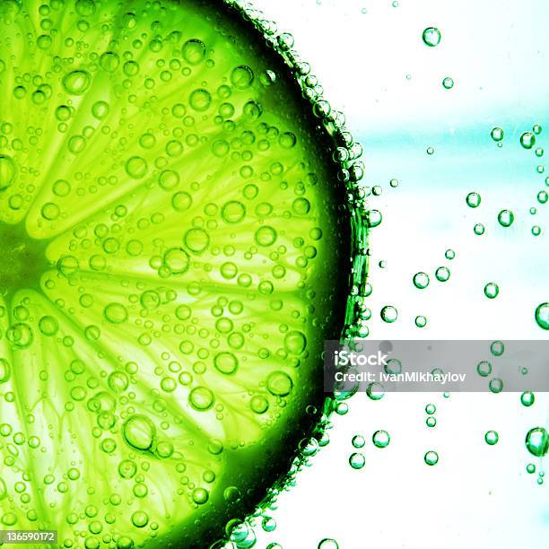 Lime Slice In Water Stock Photo - Download Image Now - Blue, Bubble, Circle