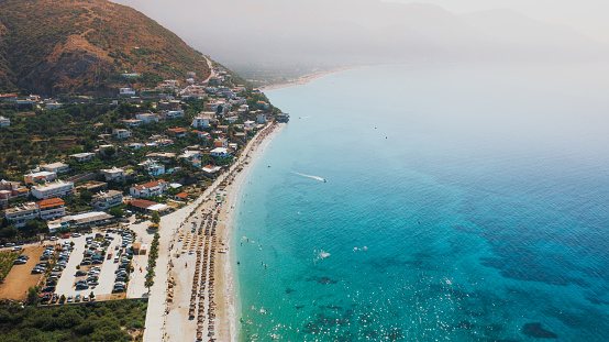 Drone panoramic photo of the summer sunset above the Ionian Sea and the summer resort in the coast of Albania, the Balkans