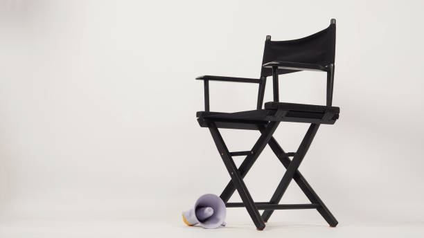 istock Black director chair and yellow megaphone on white background. 1365905146