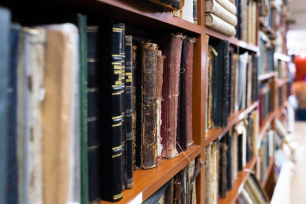 istock Blurred image of a library with bookcases. Many different books on the shelves. Large selection of books in a bookcase. Blurred background 1365905278