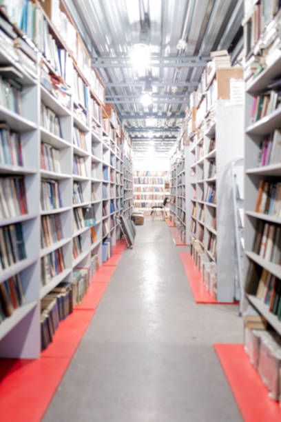 istock Blurred image of a library with bookcases. Many different books on the shelves. Large selection of books in a bookcase. Blurred background 1365906452
