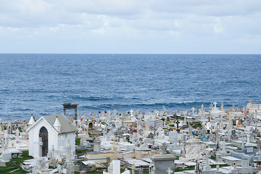 Cemetery Maria Magdalena de Pazzis, just outside El Morro in San Juan Puerto Rico.  You can see tombstones, statues, and beyond them the ocean.