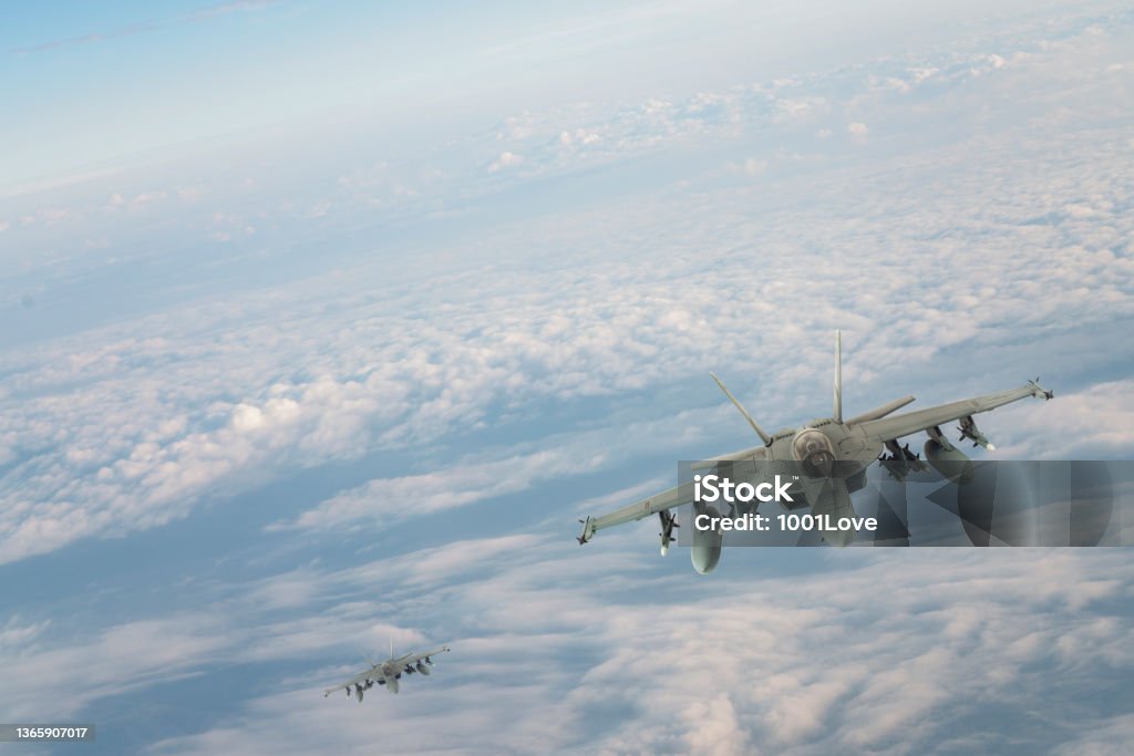 Jet fighters flying over clouds. F-18 Jet fighters flying over clouds. FA-18 Hornet Stock Photo