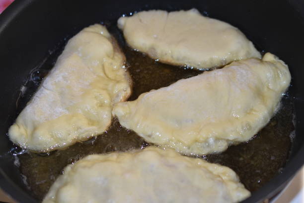 istock Cooking meat pies in a pan in the kitchen 1365907985