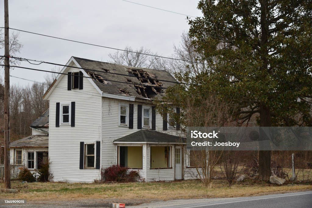 Storm Damaged Rural House Abandoned house after hurricane damage Rooftop Stock Photo