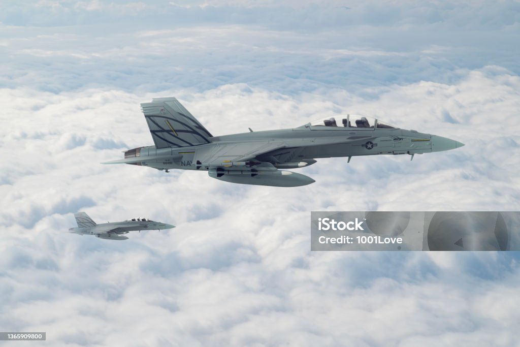 Jet fighters flying over clouds. F-18 Jet fighters flying over clouds. FA-18 Hornet Stock Photo
