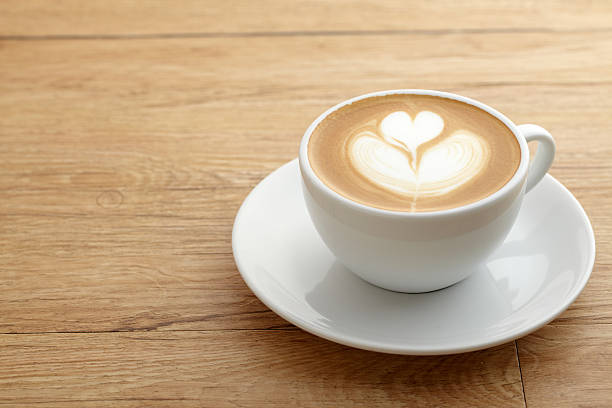 istock A latte with foam art forming a heart on a saucer on a table 136591351