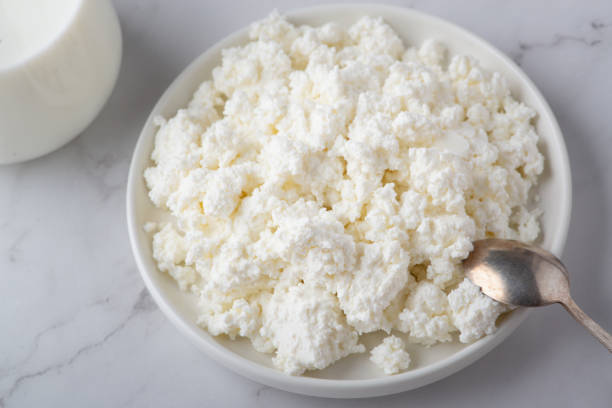 istock Bowl with fresh cottage cheese on table. Space for text 1365913924