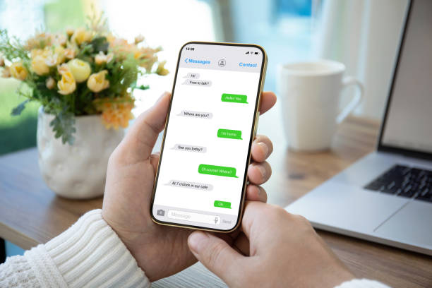 istock male hands holding phone with app messenger on the screen 1365916221