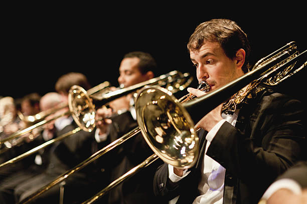 Trumpet players in orchestra  orchestra stock pictures, royalty-free photos & images
