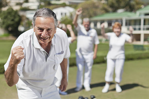 Older people playing lawn bowling  happiness four people cheerful senior adult stock pictures, royalty-free photos & images