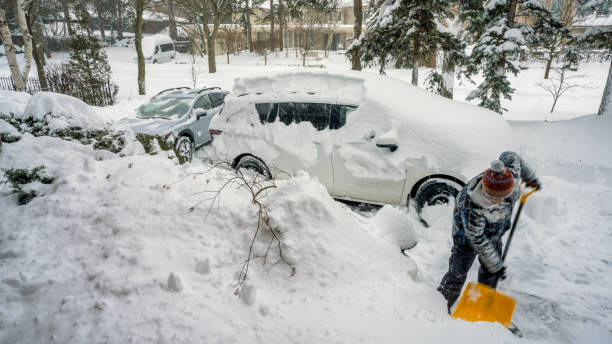 istock Man with a shovel cleans the track from the snow 1365921020