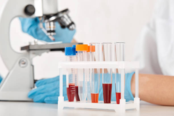 istock stand with test tubes on the background of a microscope 1365923134