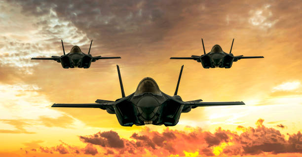 F-35 fighter jets flying over clouds stock photo