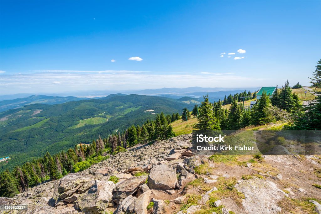 View of the Spokane, Washington Area from the top of Mount Spokane. Steep mountain and lake views from the peak of Mt Spokane State Park overlooking the Spokane Washington, USA area on a summer day. Valley Stock Photo