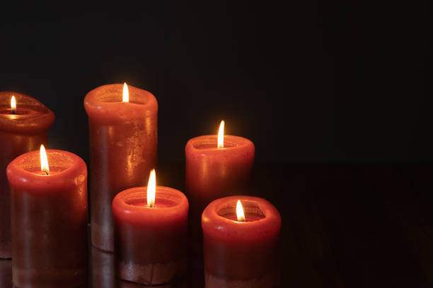 istock Red candles burning in the dark 1365923341